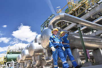 Terminal engineers inspecting large petroleum pipeline equipment
